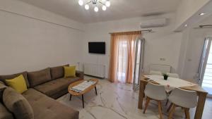 a living room with a couch and a table at Aegean Horizon Apartment in Skala Marion