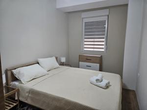 a bedroom with a bed with a towel on it at Zen Central Gevgelija in Gevgelija