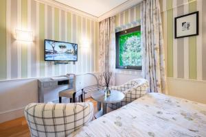 Кровать или кровати в номере Cala del Porto Punta Ala - Preferred Hotels