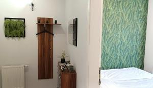 a bedroom with a bed and a green wall at Nidius Apartment in Debrecen