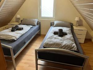 two twin beds in a room with a attic at Big Apartment 2 in Villingen-Schwenningen