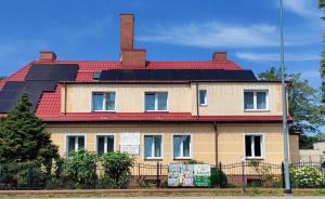 a house with solar panels on the roof at Jaśmin -baza noclegowa in Ustka
