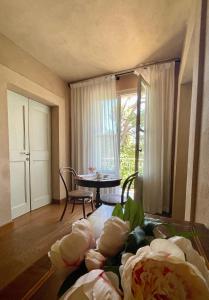 a living room with a table and a dining room at Villa Mariotti in Fano