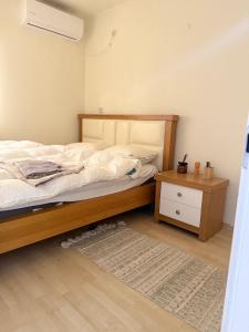 a bedroom with a bed and a night stand at וילה נקודה בכנרת in Had Nes