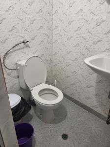 a bathroom with a toilet and a sink at Апартамент Стоянови in Primorsko