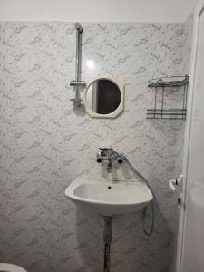 a bathroom with a sink and a mirror on the wall at Апартамент Стоянови in Primorsko