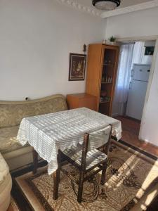 a living room with a table and a couch at Апартамент Стоянови in Primorsko +12 photos