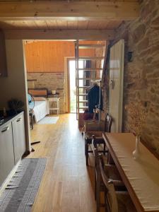 a room with a dining table and a bedroom at Agriturismo Il Tesoro di MiRo in Cartosio