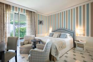 Кровать или кровати в номере Cala del Porto Punta Ala - Preferred Hotels