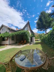 a glass table in the yard of a house at Infinity by the River in Kumanovo