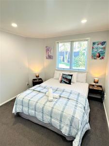 a bedroom with a large bed with two night stands at Relax near Auckland city & enjoy in Auckland