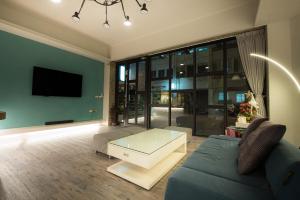 a living room with a couch and a coffee table at MUNA Hostel in Hualien City +25 photos