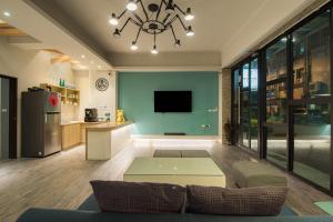 a living room with a couch and a table at MUNA Hostel in Hualien City
