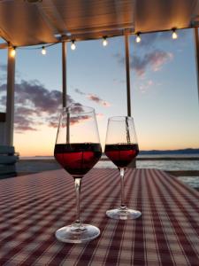 two glasses of red wine sitting on a table at Crystal Sea in Sutivan
