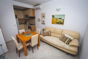 a living room with a couch and a table at Apartment Karla&Nella in Stobreč +34 photos