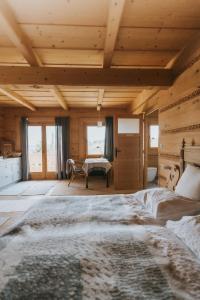 a bedroom with a large bed in a room with wooden ceilings at Nowe Miejsce Brzegi in Brzegi