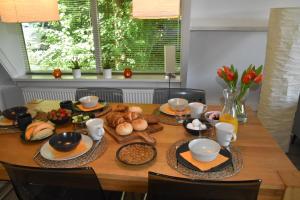 a dining room table with food on it at De Oranje Kabouter in Durbuy