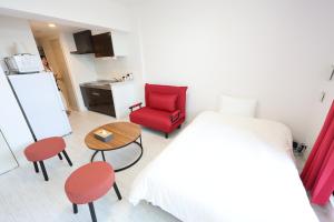a bedroom with a red chair and a table at The Marina Bay in Fukuoka