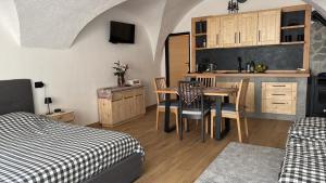 a room with a kitchen and a table with chairs at Coriva Homes - Cogolo Stube in Cogolo +14 photos