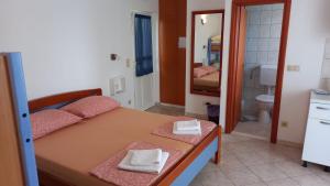 a bedroom with a bed with two towels on it at Villa Nada - STUDIO 11 in Duće