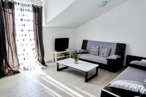 a living room with a couch and a coffee table at Villa Dragic in Brodarica