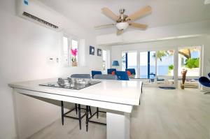 a kitchen and living room with a ceiling fan at Oceanfront Bungalow Cable Beach 2 Bedroom in Macbride +9 photos