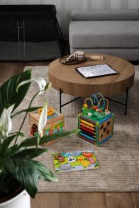 a coffee table with toys on the floor in a living room at Kilian Suite in Miskolc