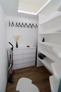 a white room with a chair and a desk at Kilian Suite in Miskolc +26 photos