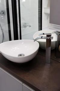 a white sink on a counter in a bathroom at Kilian Suite in Miskolc