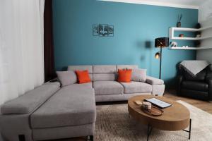 a living room with a couch and a table at Kilian Suite in Miskolc