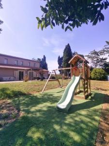 a playground with a slide in a yard at La Torretta in Piombino