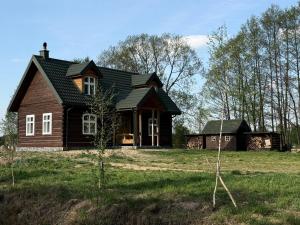a house on a grassy field with trees at Brzozowisko in Brzozówka +29 photos