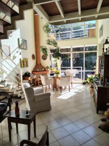 a living room with white furniture and a large window at LOFT en Condominio Central in Campinas