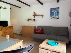 a living room with a couch and a table at Cozy appartement style chalet in Torgon