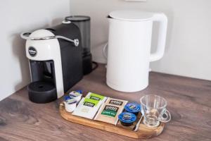a coffee maker sitting on a table next to a coffee maker at Harmonia Apartments in Bitola