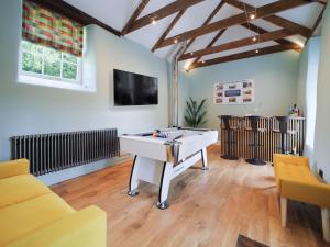 a living room with a pool table and a tv at Polmear Farm Manor House in Charlestown