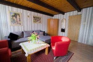 a living room with a couch and a table and chairs at Agroturystyka Uroczysko in Sianów