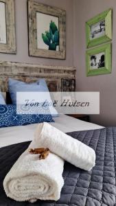 a hotel room with a towel on a bed at Von Loë Huizen in Fauresmith
