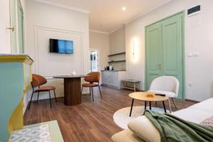 a living room with a bed and a table and chairs at Harmonia Apartments in Bitola