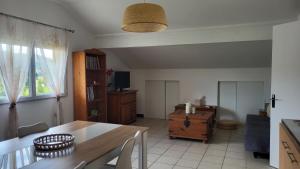 a living room with a table and a dining room at les chambres de Mélis in Crémieu