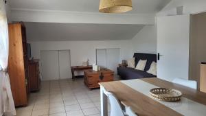 a living room with a table and a couch at les chambres de Mélis in Crémieu