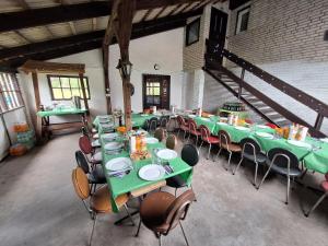 a group of tables and chairs in a room at Agroturystyka Uroczysko in Sianów