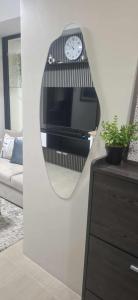 a mirror on a wall in a living room at House of Lilith at Kasara in Manila