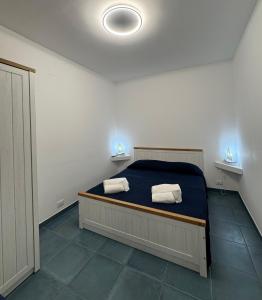a bedroom with a bed with two towels on it at Casa Vacanze Marinella Beach in San Vito lo Capo