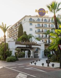 a large white hotel with palm trees in front of it at Marbella urbanización privada in Marbella