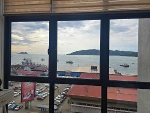 a view of a harbor from a window at The shore by seffa2 in Kota Kinabalu