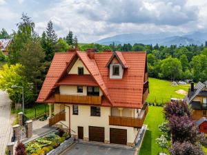 an image of a house with an orange roof at Willa Bachledzki Wierch 12 in Zakopane
