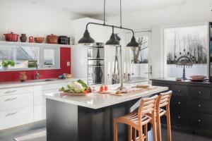 a kitchen with a counter with a plate of vegetables on it at Poolvilla på Österlen in Brantevik