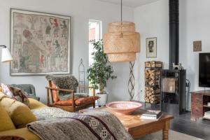 a living room with a couch and a table at Poolvilla på Österlen in Brantevik