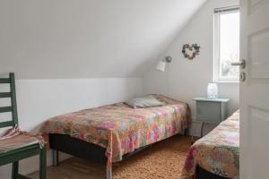 a bedroom with two beds and a window at Poolvilla på Österlen in Brantevik +3 photos